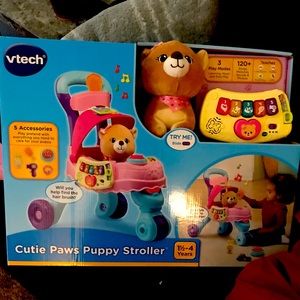 Little girls dog stroller with dog included. Brand new in box never opened